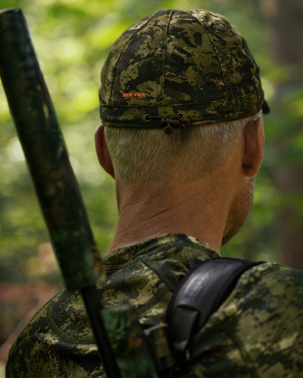 InVis Green Coloured Seeland Avail Camo Cap on forest background #colour_invis-green