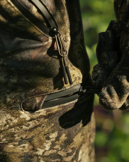 InVis Green Coloured Seeland Avail Camo Trousers on forest background #colour_invis-green