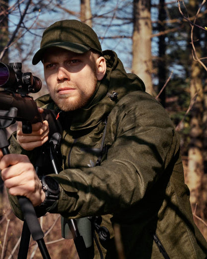 Pine Green Melange coloured Seeland Avail Jacket on forest background #colour_pine-green-melange