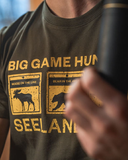 Grape Leaf Coloured Seeland Caution T-Shirt on indoor background #colour_grape-leaf