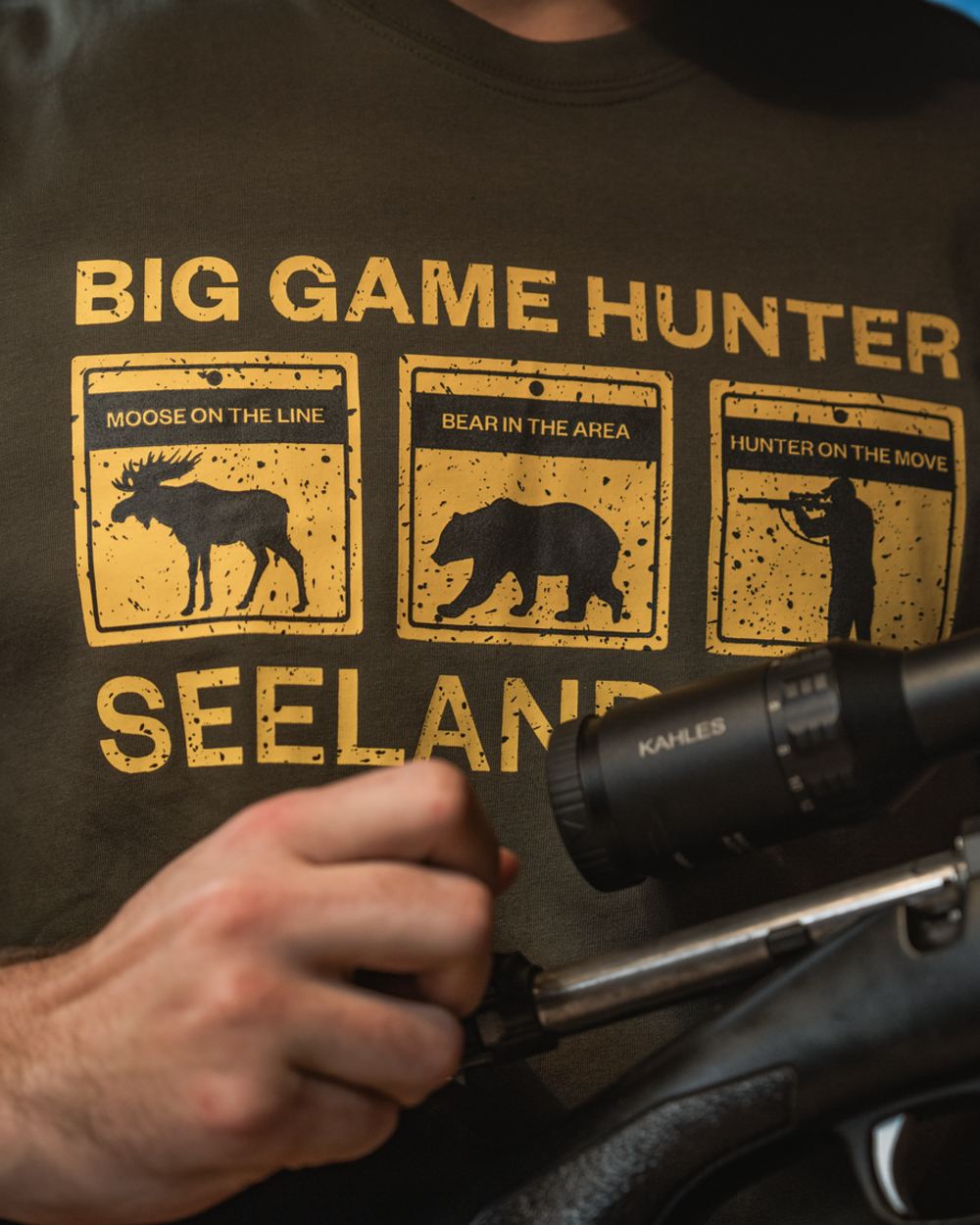 Grape Leaf Coloured Seeland Caution T-Shirt on indoor background #colour_grape-leaf