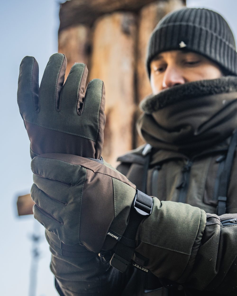 Pine Green coloured Seeland Celsius Heat Gloves on forest background #colour_pine-green