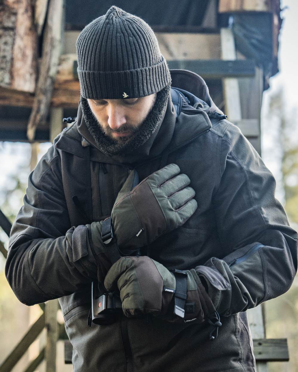 Pine Green coloured Seeland Celsius Heat Gloves on forest background #colour_pine-green