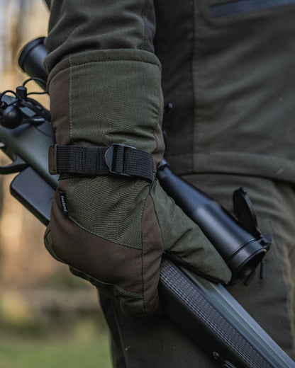 Pine Green coloured Seeland Celsius Heat Gloves on forest background #colour_pine-green