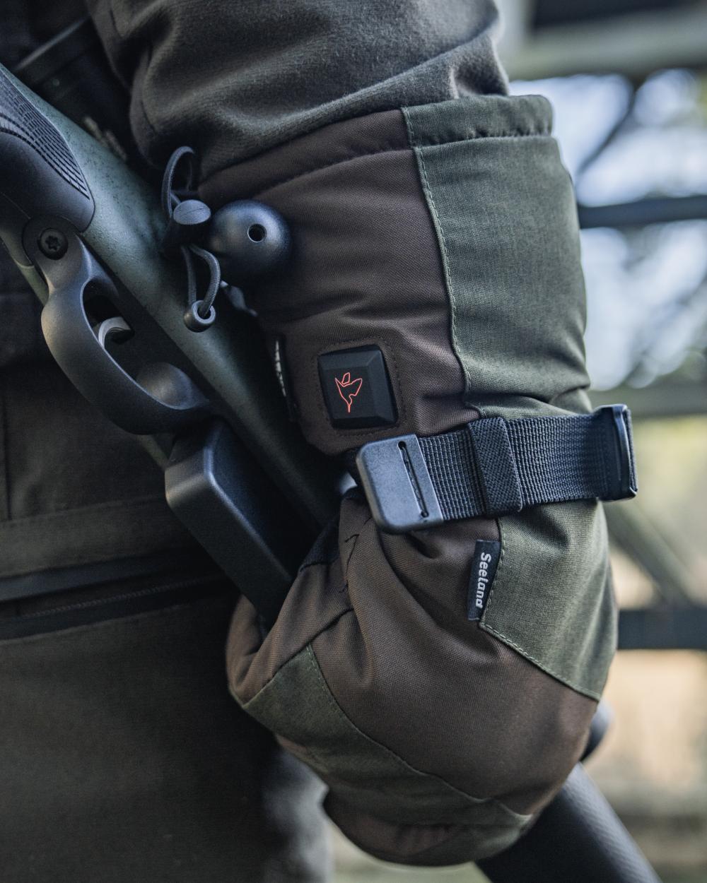 Pine Green coloured Seeland Celsius Heat Gloves on forest background #colour_pine-green