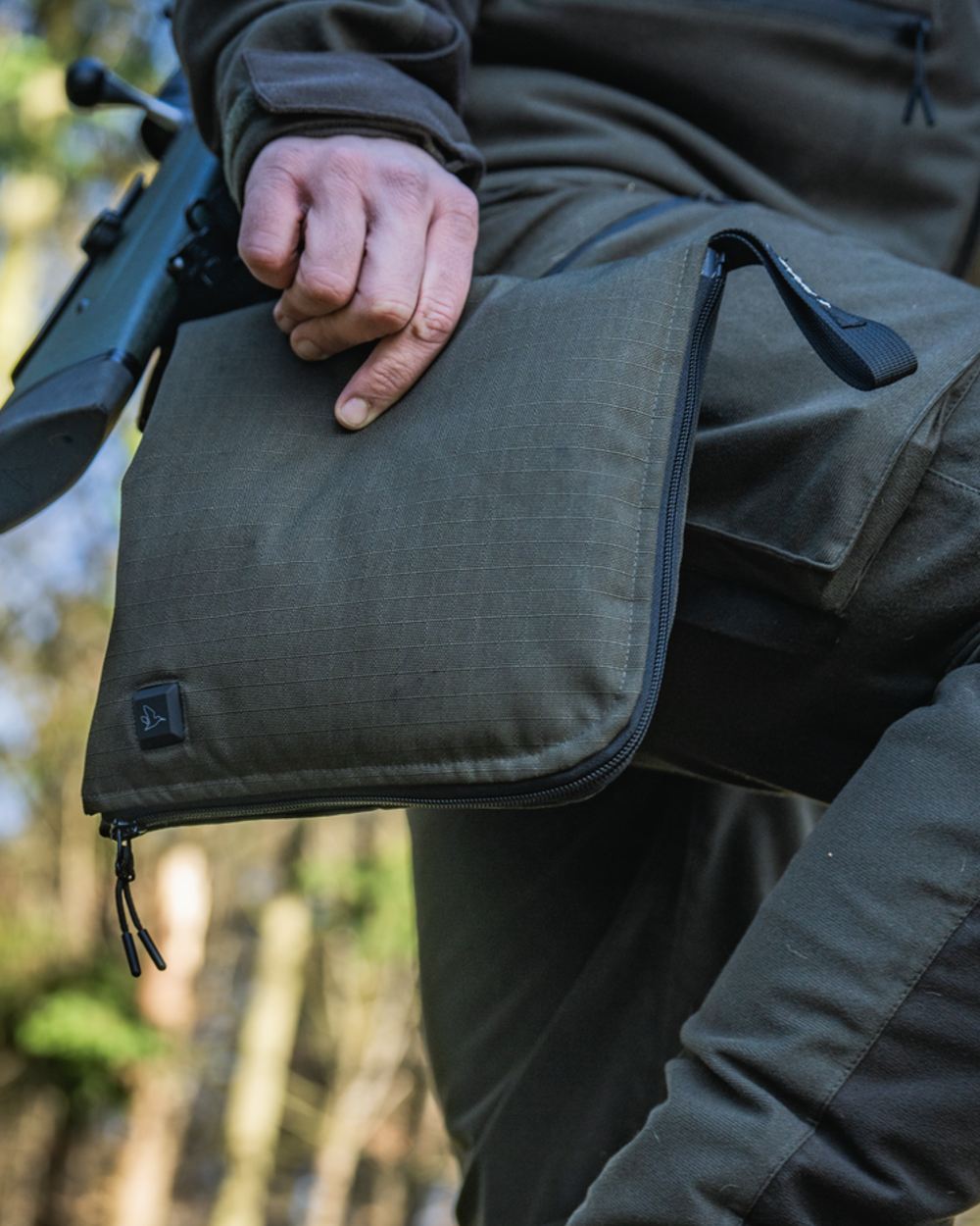 Pine Green coloured Seeland Celsius Heat Seat Pad on forest background #colour_pine-green