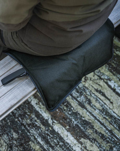 Pine Green coloured Seeland Celsius Heat Seat Pad on forest background #colour_pine-green