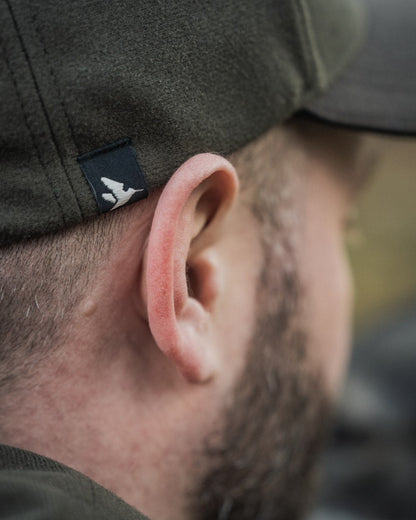 Pine Green coloured Seeland Chaser BGH Cap on forest background #colour_pine-green