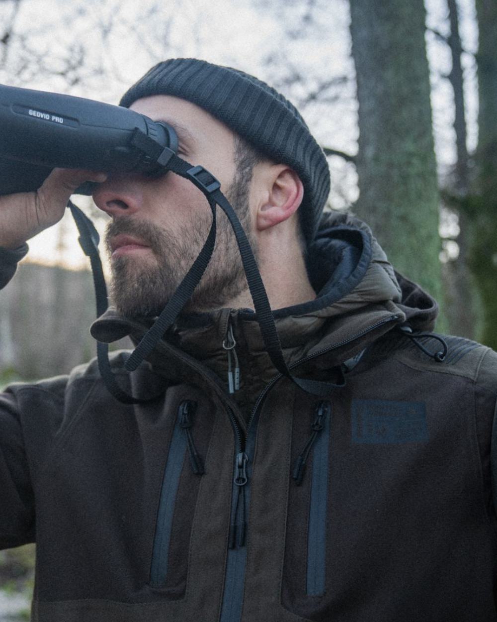 Pine Green Coloured Seeland Chaser Jacket on forest background #colour_pine-green