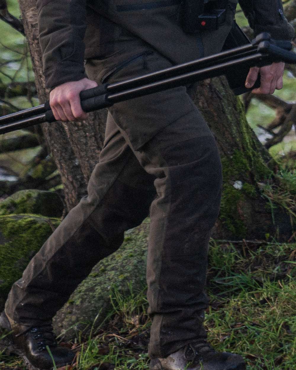 Pine Green Coloured Seeland Chaser Trousers on forest background #colour_pine-green
