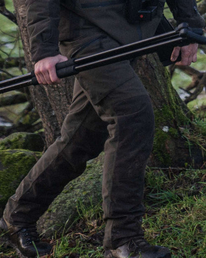 Pine Green Coloured Seeland Chaser Trousers on forest background #colour_pine-green