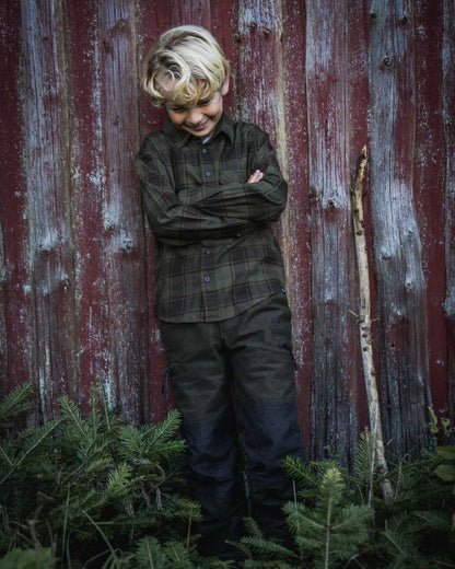 Pine Green Dark Navy Check Coloured Seeland Childrens Glen Flannel Shirt on outdoor background #colour_pine-green-dark-navy-check
