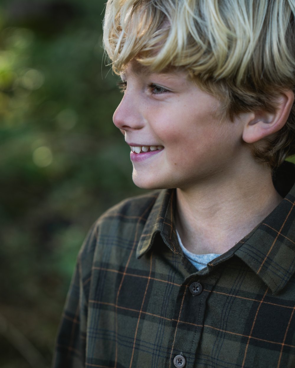 Pine Green Dark Navy Check Coloured Seeland Childrens Glen Flannel Shirt on outdoor background #colour_pine-green-dark-navy-check