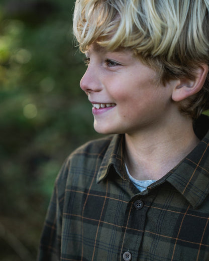 Pine Green Dark Navy Check Coloured Seeland Childrens Glen Flannel Shirt on outdoor background #colour_pine-green-dark-navy-check
