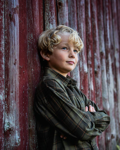 Pine Green Dark Navy Check Coloured Seeland Childrens Glen Flannel Shirt on outdoor background #colour_pine-green-dark-navy-check
