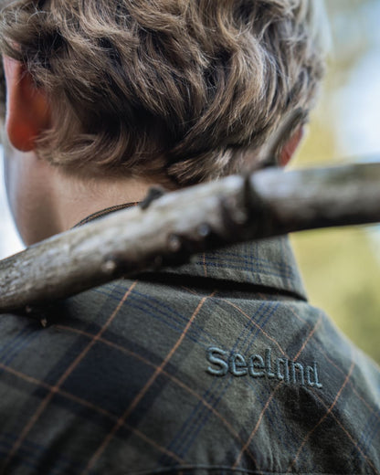 Pine Green Dark Navy Check Coloured Seeland Childrens Glen Flannel Shirt on outdoor background #colour_pine-green-dark-navy-check