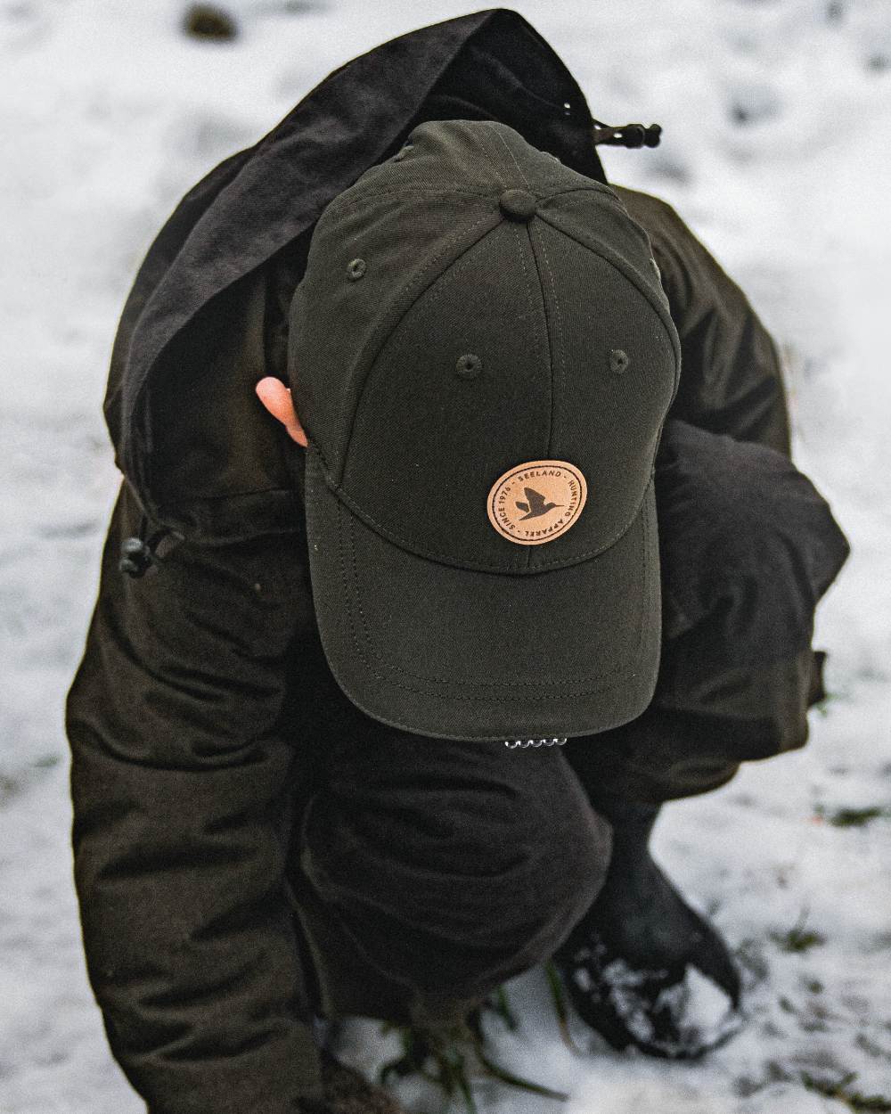 Pine Green coloured Seeland Childrens Skarn LED Junior Cap on forest background #colour_pine-green