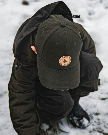 Pine Green coloured Seeland Childrens Skarn LED Junior Cap on forest background #colour_pine-green