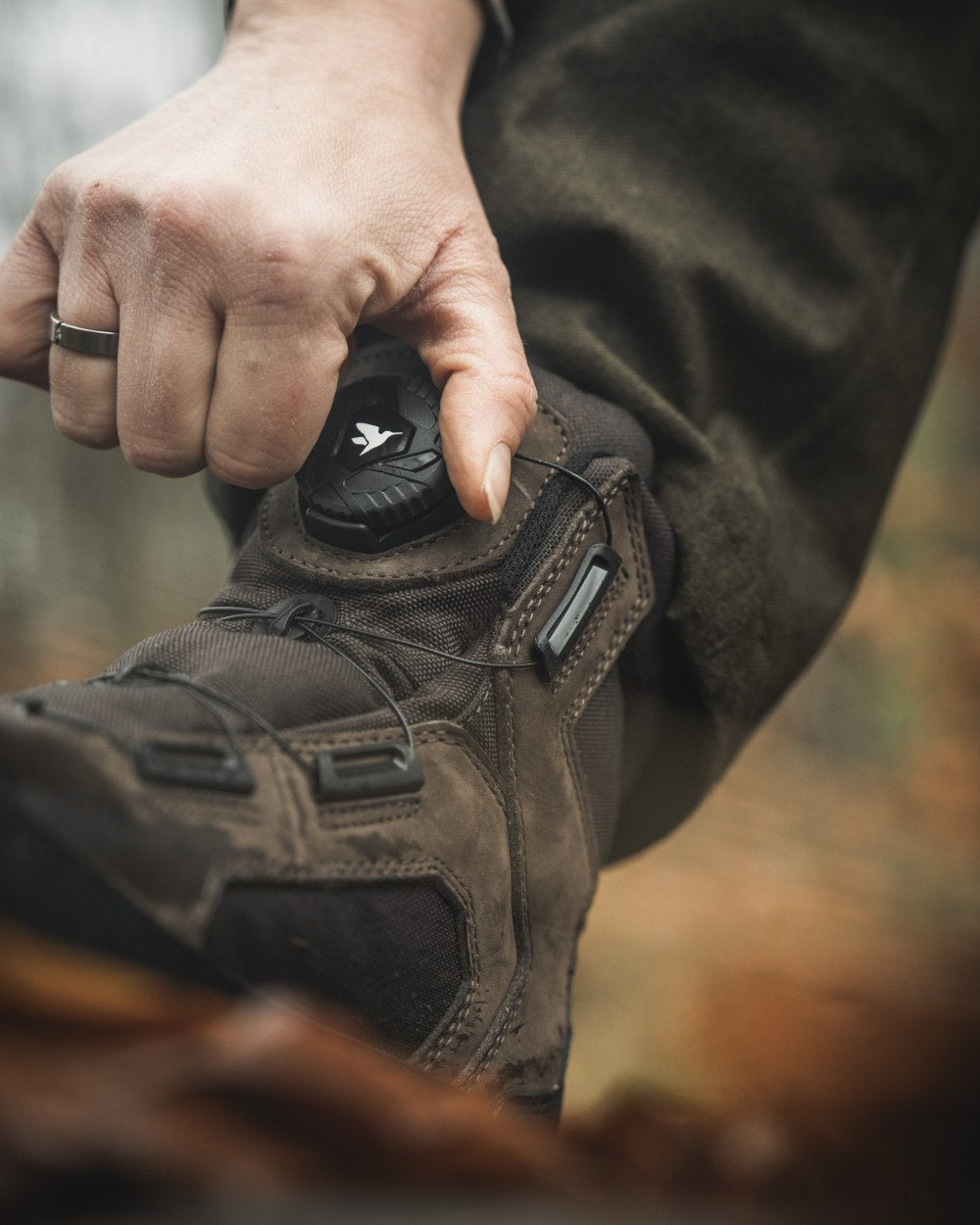 Dark Brown coloured Seeland Enduro Dial Aya Boots on forest background #colour_dark-brown