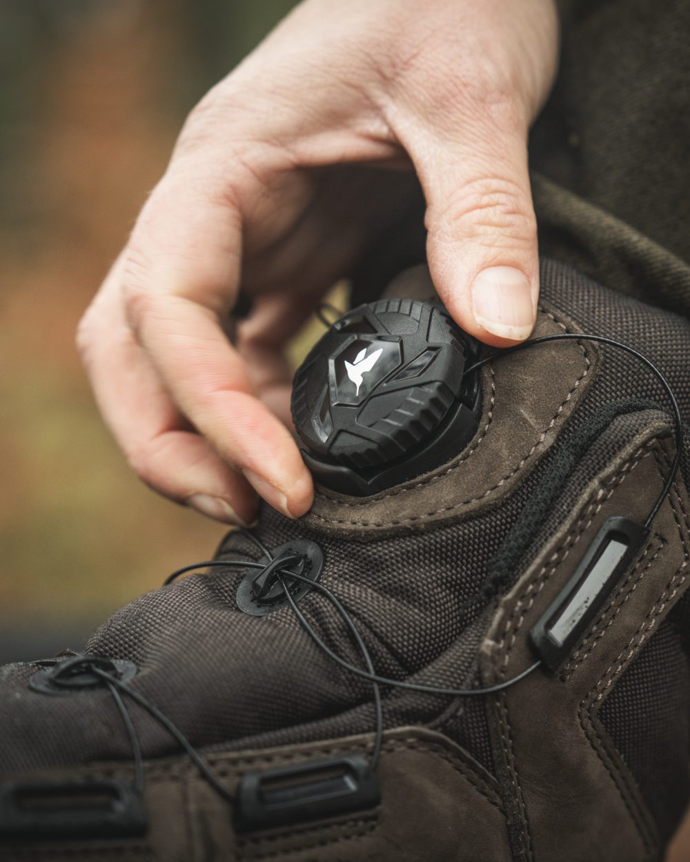 Dark Brown coloured Seeland Enduro Dial Aya Boots on forest background #colour_dark-brown