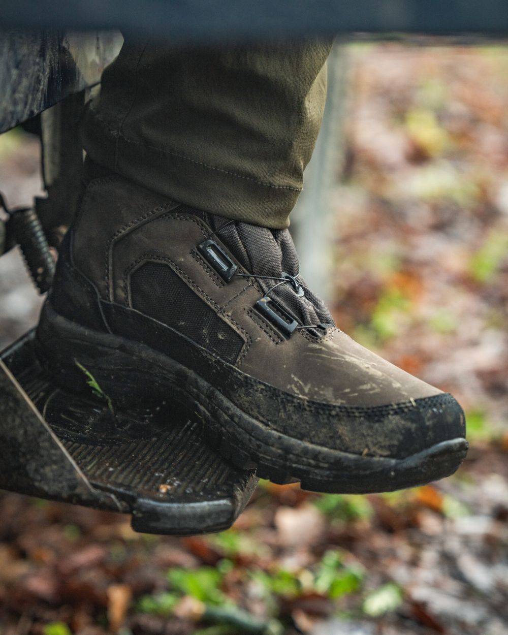Dark Brown coloured Seeland Enduro Dial Mid Boots on forest background #colour_dark-brown