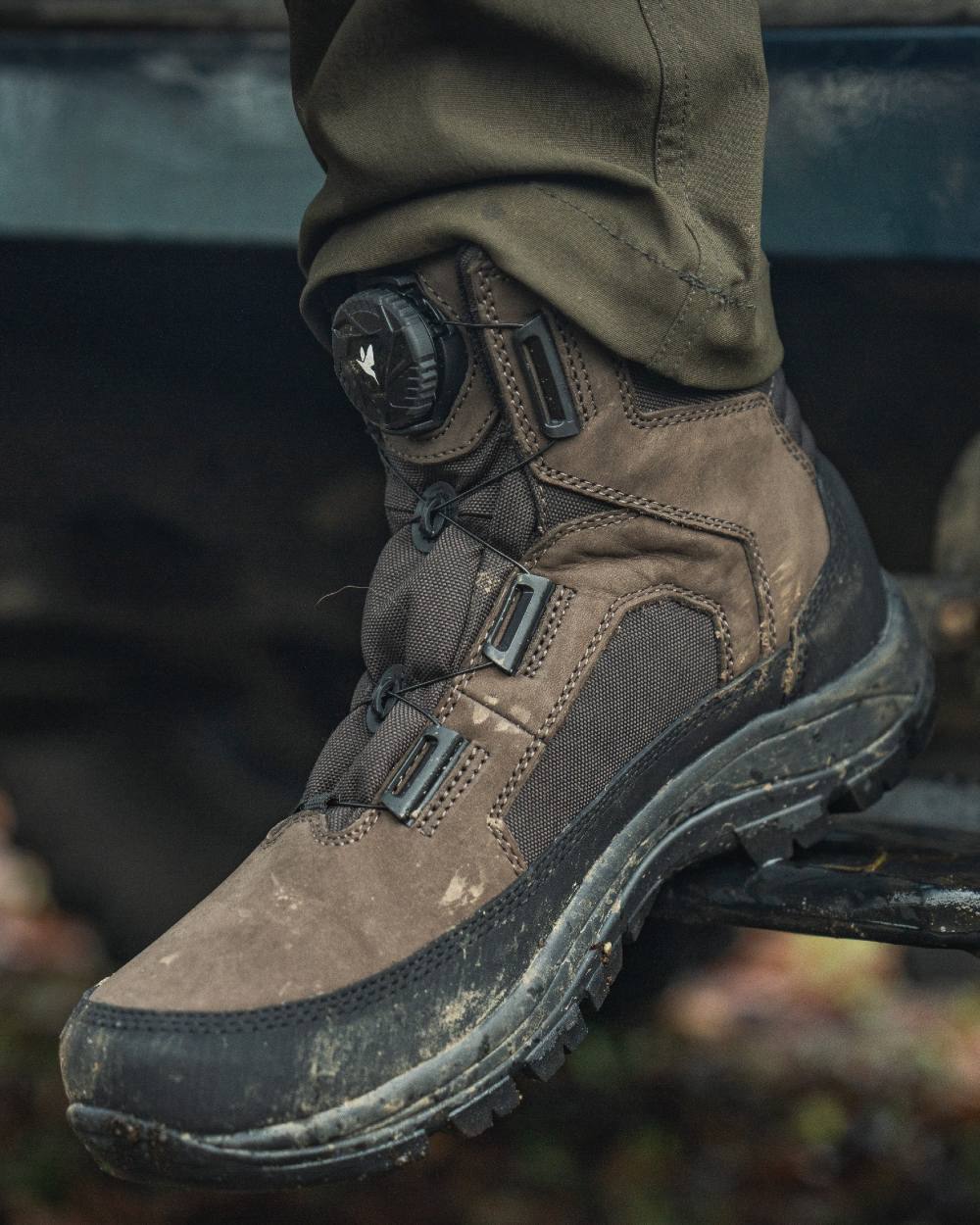 Dark Brown coloured Seeland Enduro Dial Mid Boots on forest background #colour_dark-brown