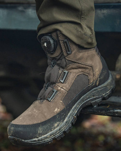 Dark Brown coloured Seeland Enduro Dial Mid Boots on forest background #colour_dark-brown