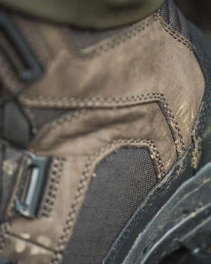 Dark Brown coloured Seeland Enduro Dial Mid Boots on forest background #colour_dark-brown