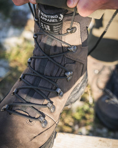 Dark Brown coloured Seeland Enduro Explore Mid Boots on forest background #colour_dark-brown