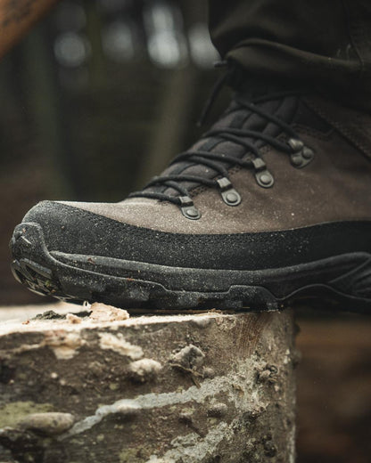 Dark Brown coloured Seeland Enduro Explore Mid Boots on forest background #colour_dark-brown