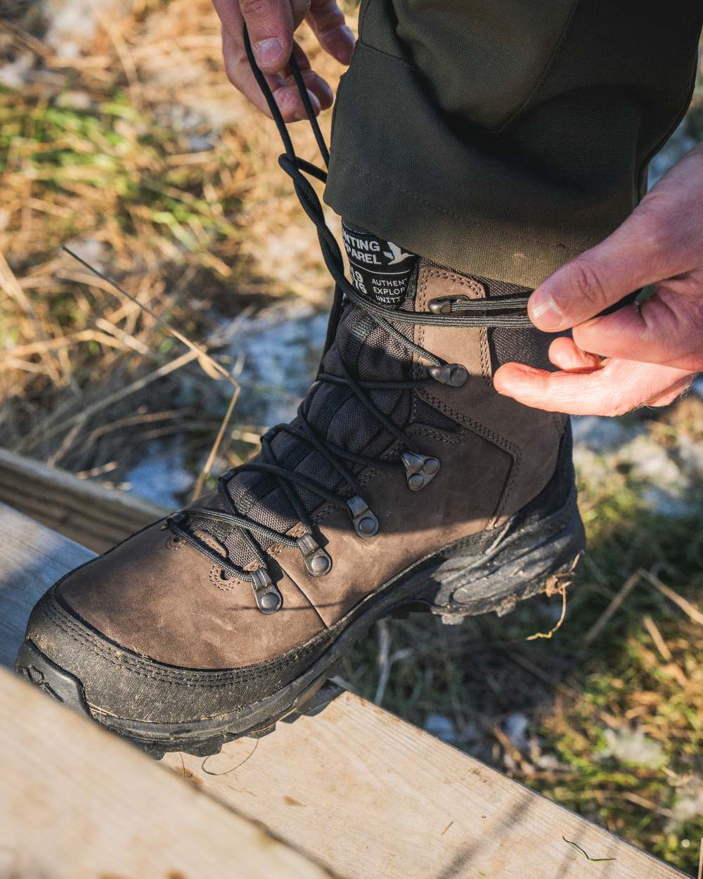 Dark Brown coloured Seeland Enduro Explore Mid Boots on forest background #colour_dark-brown
