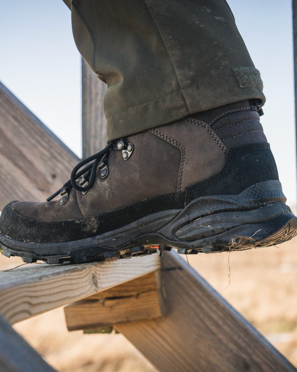 Dark Brown coloured Seeland Enduro Explore Mid Boots on outdoor background #colour_dark-brown