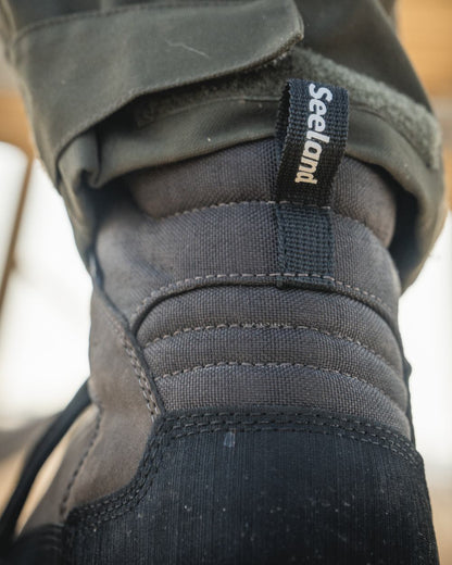 Dark Brown coloured Seeland Enduro Explore Mid Boots on outdoor background #colour_dark-brown