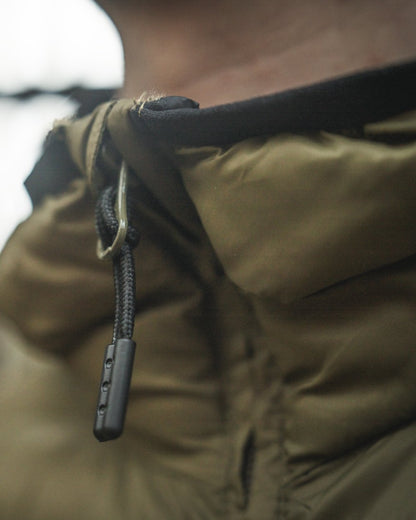 Military Olive coloured Seeland Fahrenheit Jacket on blurry background #colour_military-olive