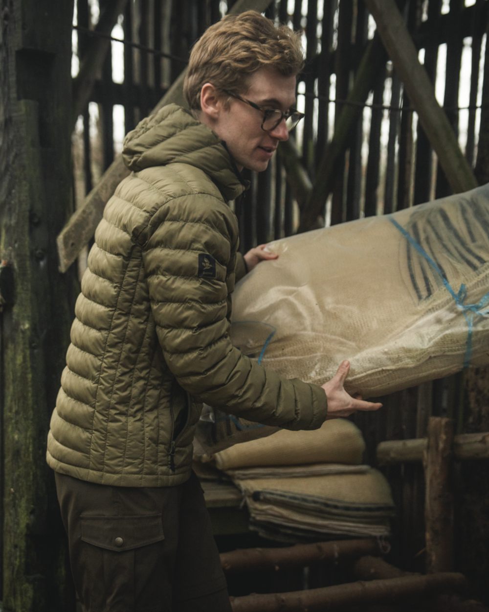 Military Olive coloured Seeland Fahrenheit Jacket on forest background #colour_military-olive