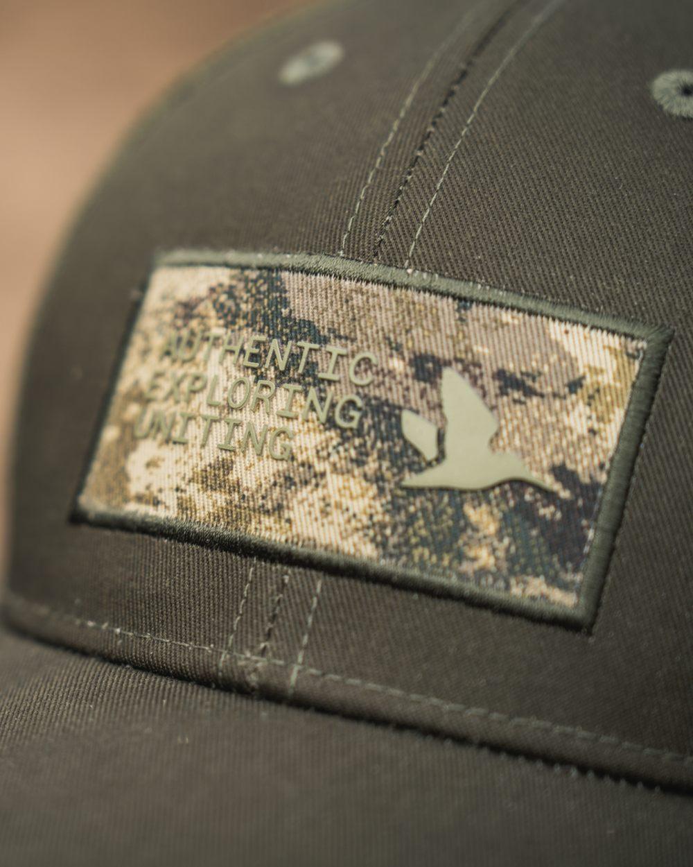Pine Green Coloured Seeland Ganister Trucker Cap on outdoor background #colour_pine-green