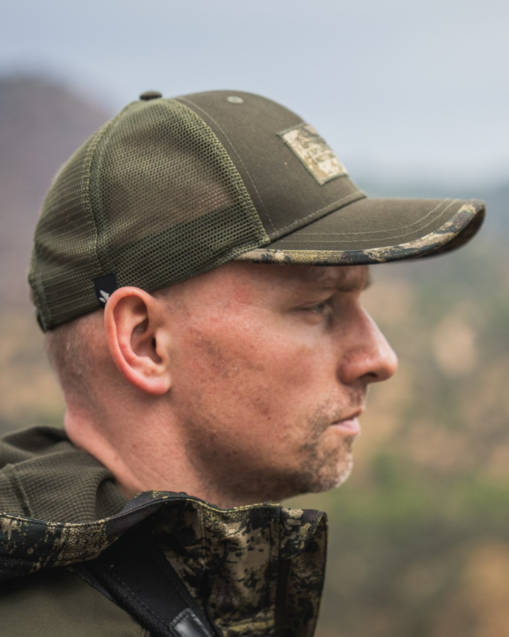 Pine Green Coloured Seeland Ganister Trucker Cap on outdoor background #colour_pine-green