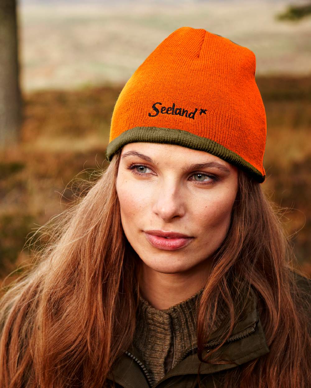 Hi-Vis Orange Pine Green Coloured Seeland Ian Reversible Beanie Hat on outdoor background #colour_hi-vis-orange-pine-green