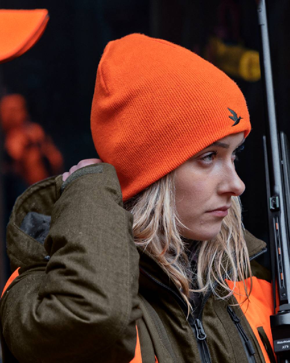 Hi-Vis Orange Pine Green Coloured Seeland Ian Reversible Beanie Hat on outdoor background #colour_hi-vis-orange-pine-green