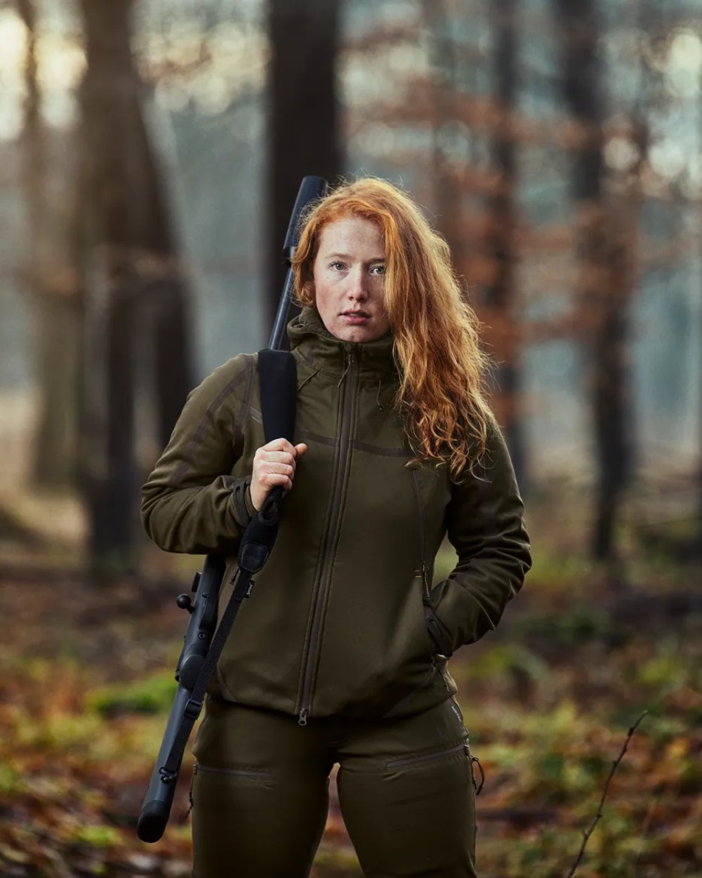 Pine Green coloured Seeland Ladies Hawker Advance Jacket on forest background #colour_pine-green