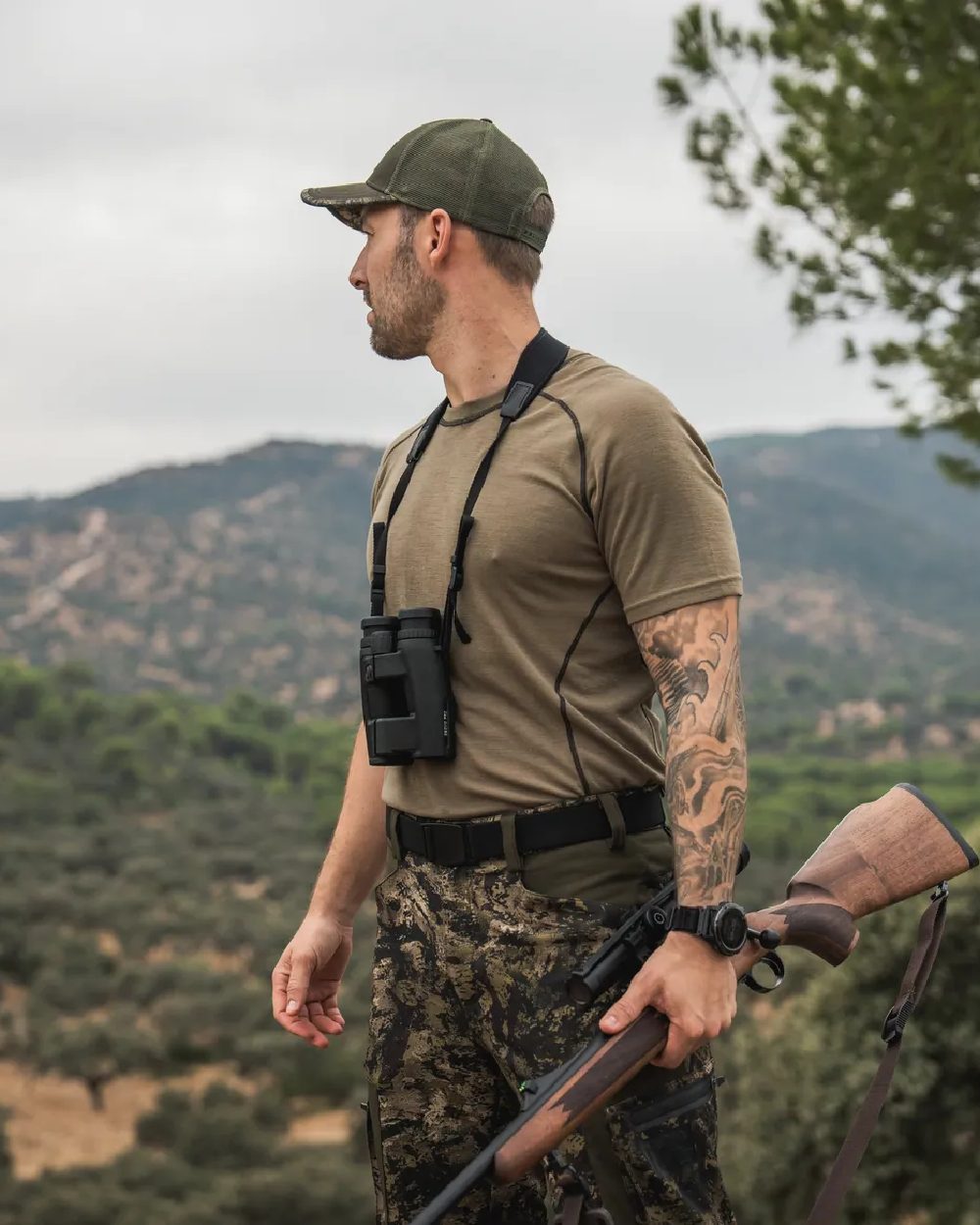 Covert Green Coloured Seeland Mens Apex Merino T-Shirt on mountain background #colour_covert-green