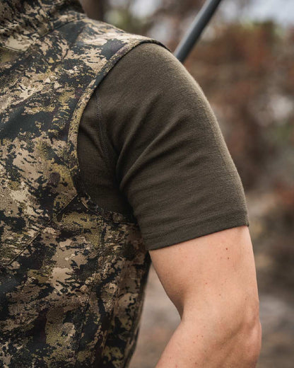 InVis MPC Green Coloured Seeland Mens Chaser Aero Camo Waistcoat on mountain background #colour_invis-mpc-green