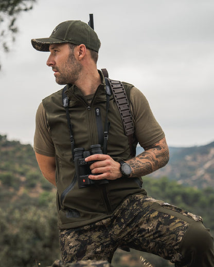 Pine Green Coloured Seeland Mens Chaser Aero Waistcoat on mountain background #colour_pine-green