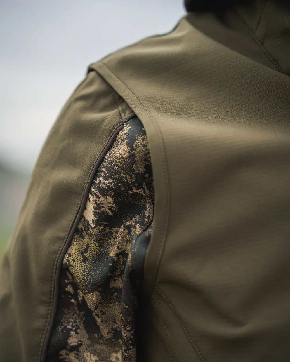 Pine Green Coloured Seeland Mens Chaser Aero Waistcoat on mountain background #colour_pine-green