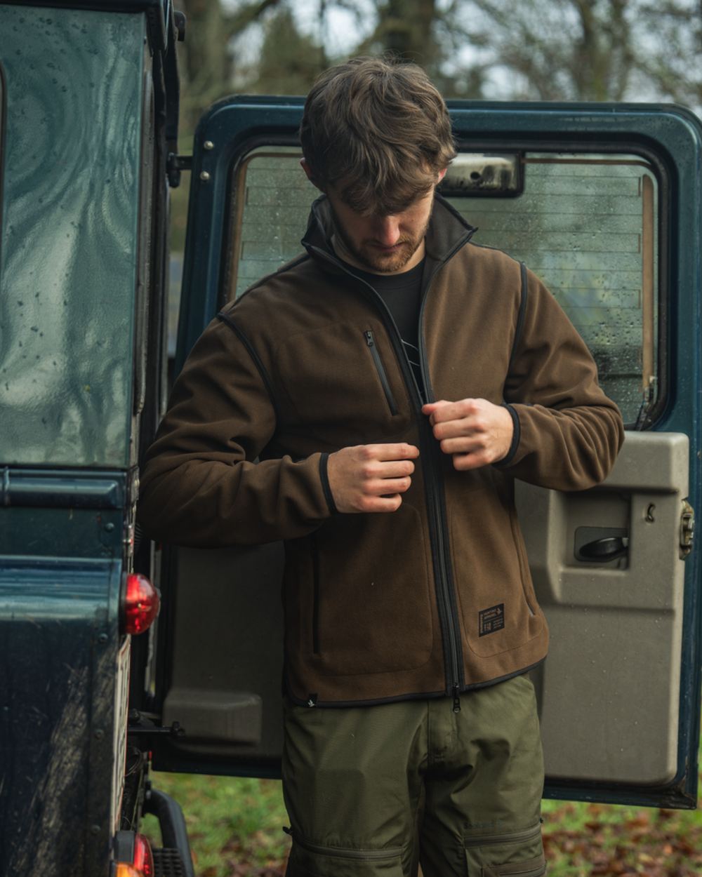 Grizzly Brown Demitasse Brown Coloured Seeland Mens Rogue Solid Reversible Fleece Jacket on forest background #colour_grizzly-brown-demitasse-brown