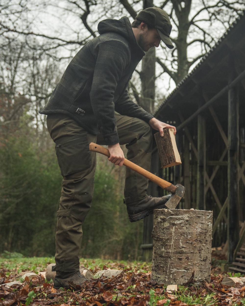 Pine Green coloured Seeland Mens Teddy Fold Down Cap on forest background #colour_pine-green