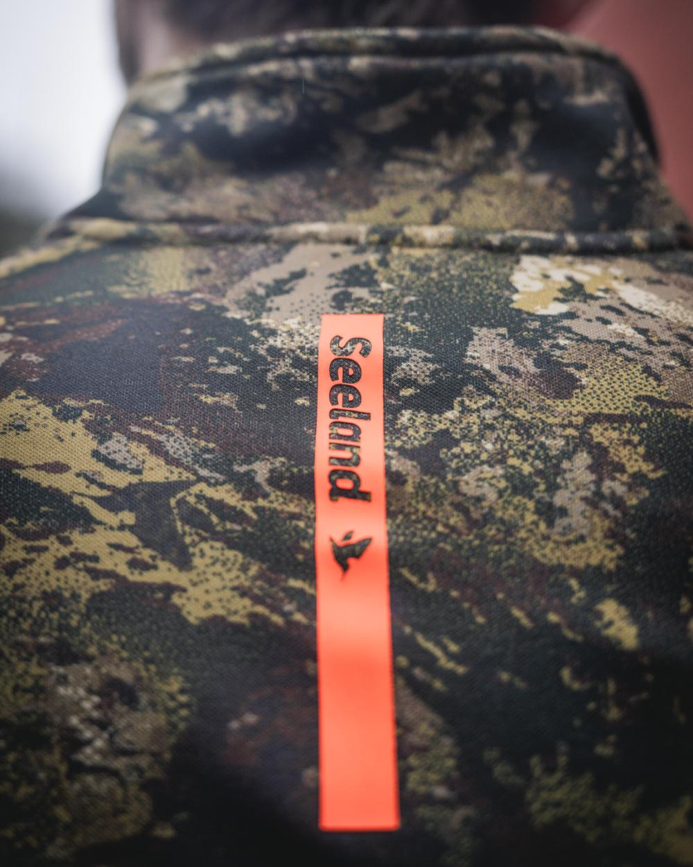 InVIS MPC Green Coloured Seeland Mens Tidal Camo Fleece Jacket on forest background #colour_invis-mpc-green