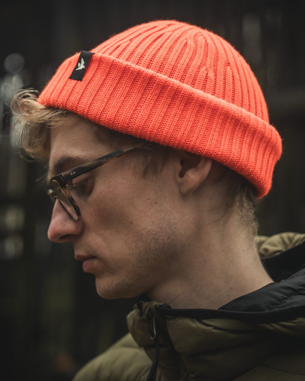 Orange Blaze Coloured Seeland Norite Beanie On A forest Background #colour_orange-blaze