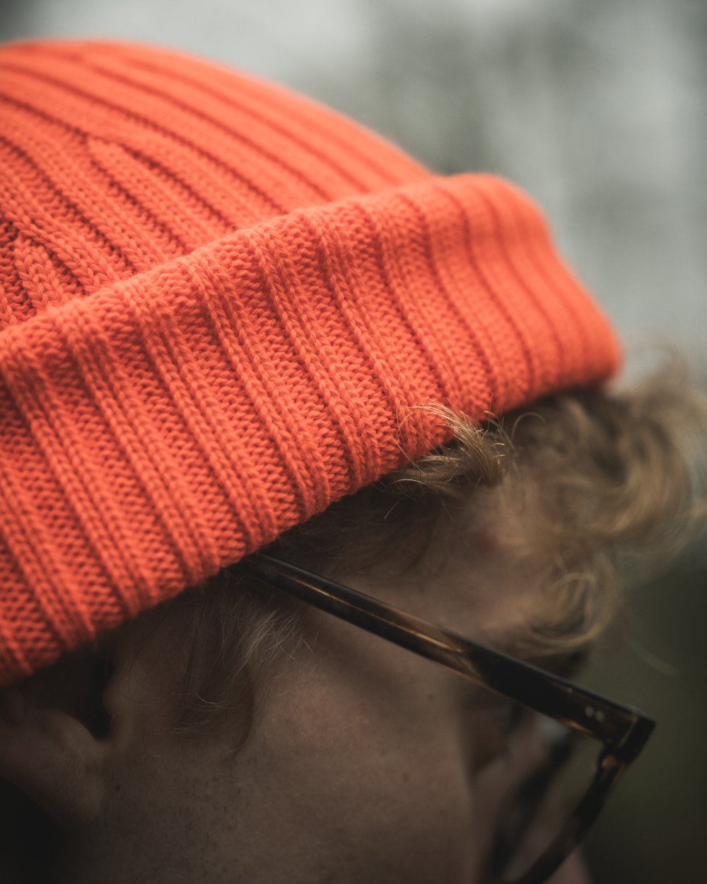 Orange Blaze Coloured Seeland Norite Beanie On A forest Background #colour_orange-blaze