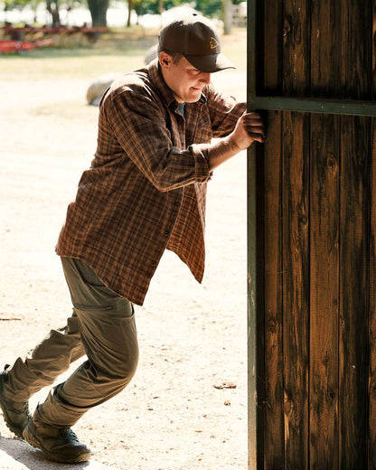 Pine Green Coloured Seeland Outdoor Stretch Trousers on outdoor background #colour_pine-green